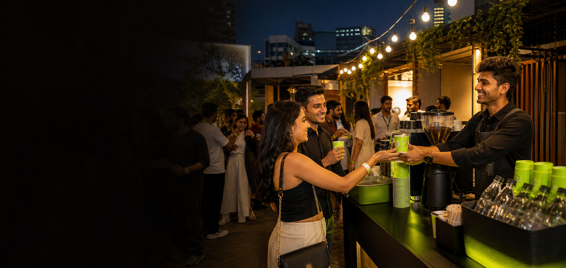 A barista serving coffee at a lively urban evening event
