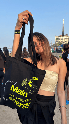 An AB Coffee guest holding community merchandise